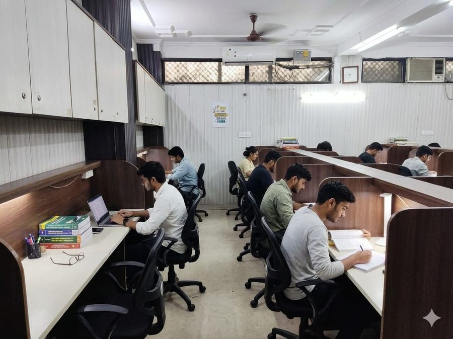 Student watching lecture on tablet with earbuds — Achievers Library Dwarka