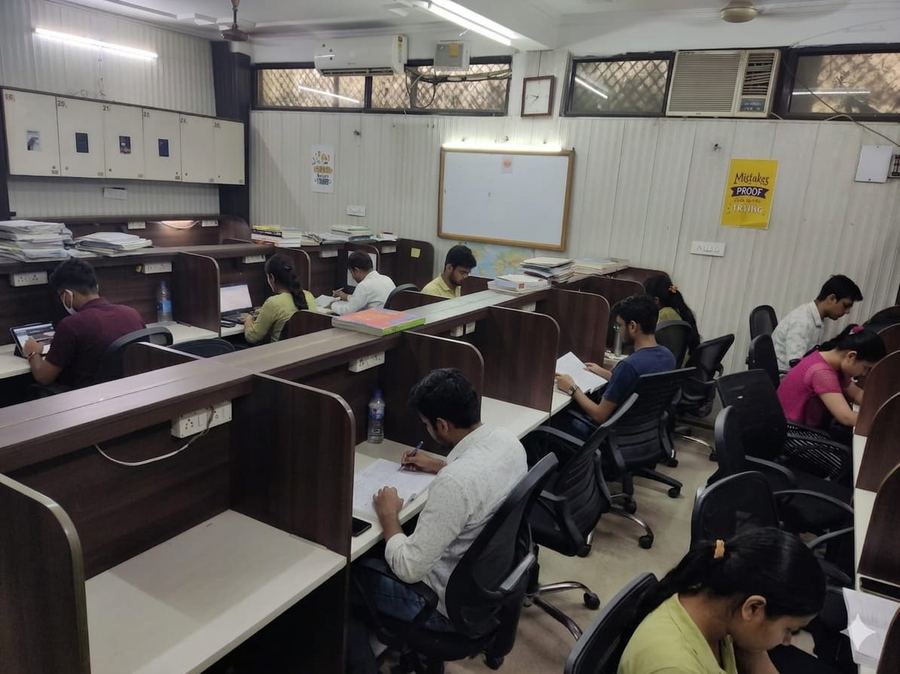 Fully occupied study hall — Welcome Students banner — Achievers Library Dwarka