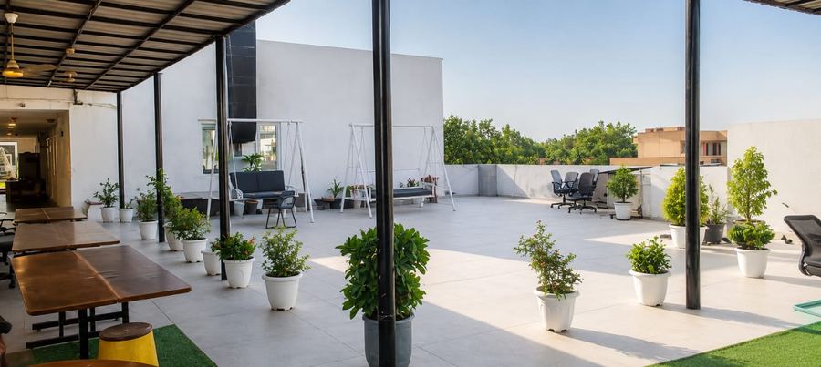 Spacious rooftop terrace with swing seating and plants — Achievers Library Paschim Vihar