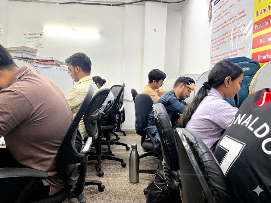 Student using tablet for online lecture with earbuds — Achievers Library Rohini